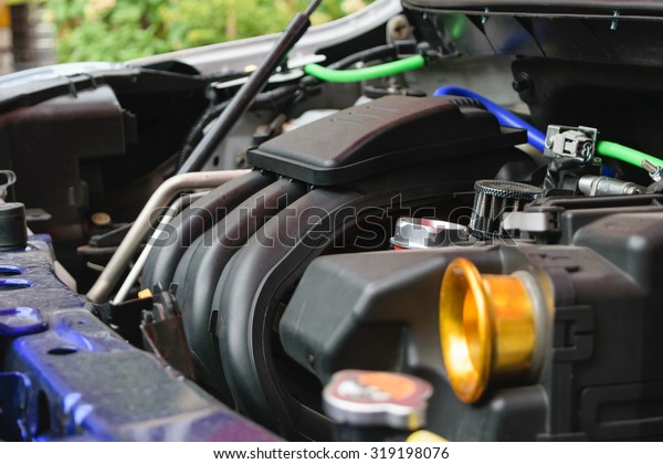 Closeup photo of a clean car engine. Selective focus\
on air flow