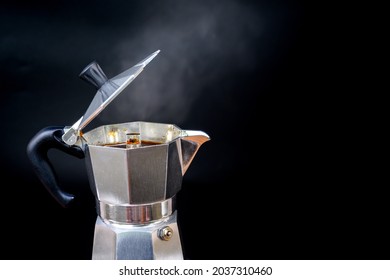 close-up photo of coffee pot Italian Moka coffee pot Moka pot with coffee brewing isolated on a black background