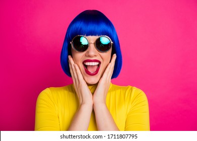 Closeup photo of cool excited lady hold arms on cheekbones wear stylish round retro specs yellow turtleneck blue short shine blue wig isolated vibrant pink color background