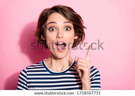 Closeup photo of crazy lady funny facial expression open mouth raise finger have amazing creative candid idea wear casual white blue t-shirt isolated pastel pink color background
