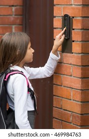 Closeup Photo Of Cute Schoolgirl Ringing In Doorbell