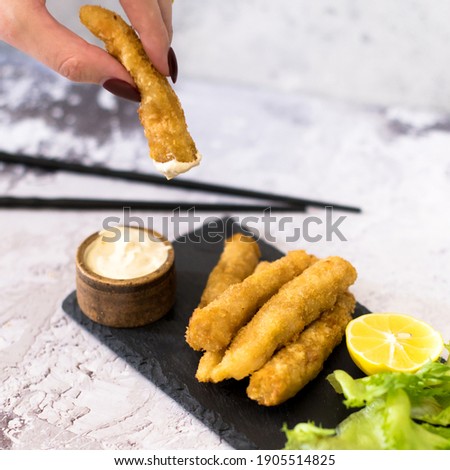 Close-up photo of deep fried shrimps with garlic sauce on the grey background