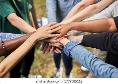 close-up photo of diverse people's hands gathered together, african american and caucasian people as one union. various ethnicities are friends all over the world