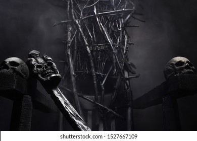 Close-up Photo Of  Evil Witch Throne Made Of Branches With Skulls And Cane, On Foggy Black Background.