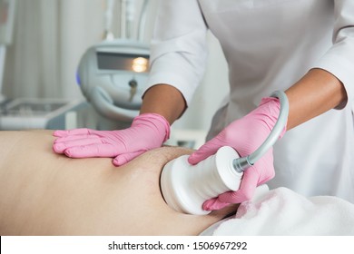 Closeup photo of fat man with big belly having cavitation procedure removing cellulite on abdomen in modern beauty clinic