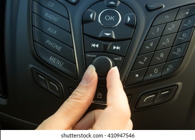 Closeup Photo Of Female Driver Adjusting Car Stereo System