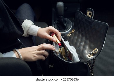 Closeup Photo Of Female Driver Searching For Lipstick In Purse