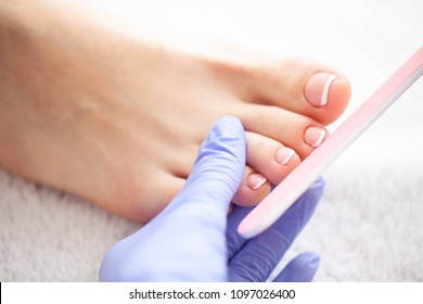 Closeup Photo of a Female Feet at Spa Salon on Pedicure Procedur.Care. Beautiful Women's Feet with Pedicure in Beauty Salon. Spa Manicure.