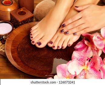 Closeup photo of a female feet at spa salon on pedicure procedure. Female legs in water decoration  the flowers. - Powered by Shutterstock