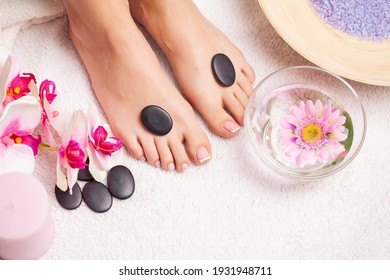 Closeup photo of a female feet at spa salon on pedicure procedure