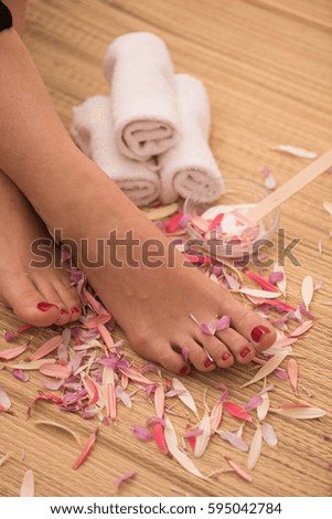 Closeup photo of a female feet at spa salon on pedicure and manicure procedure