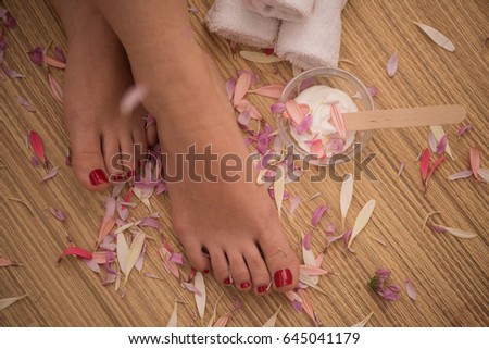 Closeup photo of a female feet at spa salon on pedicure and manicure procedure