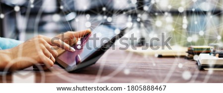 Close-up photo of female hands with digital tablet. Young woman working remotely at home. Concept of networking or remote work. Global business network. Online courses.