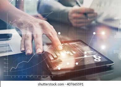 Closeup photo female hands touching screen modern tablet. Account managers working new investment project in office. Using electronic devices. Graphics icons, worldwide stock exchanges interface.  - Powered by Shutterstock