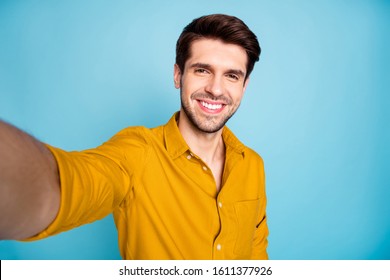 Closeup photo of freelancer business guy making selfies for social blog post excited positive weekend mood wear yellow shirt isolated blue color background