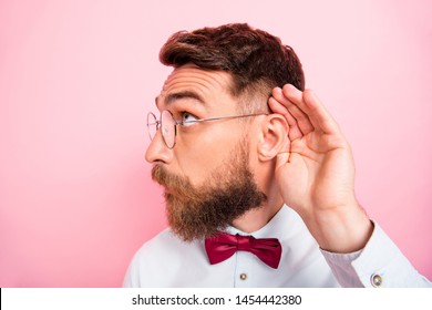 Close-up photo of funny funky smart concentrated hipster gentleman holding palm near ear catching familiar sound isolated pastel background - Shutterstock ID 1454442380