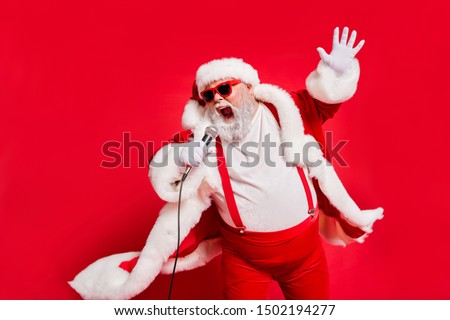 Closeup photo of funny funky wild vocalist screaming in microphone wearing fur coat gloves suspenders isolated bright background