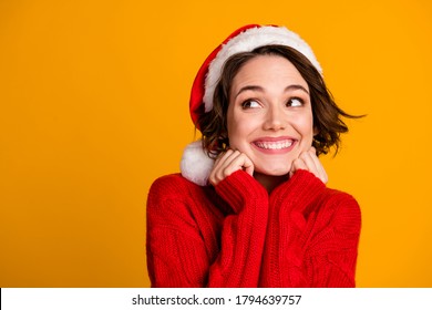 Closeup photo of funny pretty lady enjoy soft cloth laundry warmth celebrate winter holidays look empty space dreamy wear santa claus cap red knitted sweater isolated yellow color background - Powered by Shutterstock