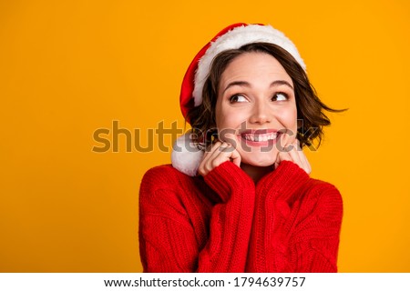 Closeup photo of funny pretty lady enjoy soft cloth laundry warmth celebrate winter holidays look empty space dreamy wear santa claus cap red knitted sweater isolated yellow color background