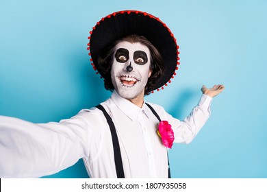 Closeup photo of funny traditional zombie creature guy death day creepy scary makeup mask masquerade make selfies show banner advert wear latin hat costume isolated blue color background