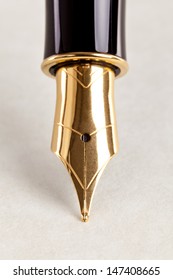 Close-up Photo Of A Gold Nib Fountain Pen On Expensive Paper.