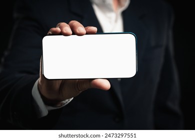 A close-up photo of a hand holding a smartphone with a blank screen. This image can be used to represent technology, communication, mobile applications, or customizable content. - Powered by Shutterstock