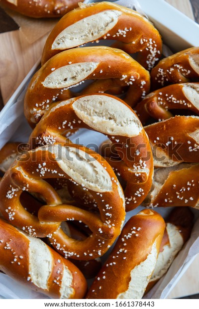 Closeup photo of handmade lye bun and bavarian\
pretzel in bakery