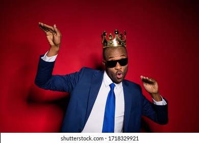 Closeup Photo Of Handsome Attractive Dark Skin Business Guy Bossy Person Dancing Office Event Golden Diadem On Head Wear Sun Specs Formalwear Suit Tuxedo Isolated Burgundy Background