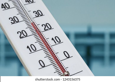 Closeup photo of household alcohol thermometer showing temperature in degrees Celsius. Against the background of a heating radiator - Shutterstock ID 1243156375