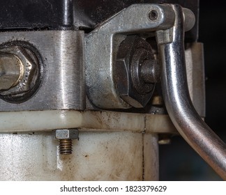 Closeup photo of hydraulic control valve on the side of the car lifting valve stem