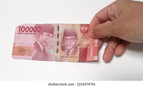 Close-up Photo Of Indonesian Money, Worth One Hundred Thousand Or 100.000 Rupiah On A White Background.