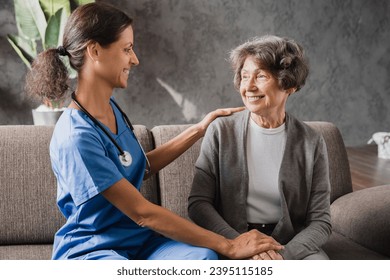Closeup photo of love and support. Medical worker nurse caregiver helping taking care of senior old handicapped disabled lady woman in hospice at home. Geriatrics - Shutterstock ID 2395115185