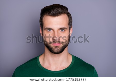 Closeup photo of macho attractive guy perfect appearance neat groomed hairdo bristle not smiling clever eyes wear casual green t-shirt isolated grey color background