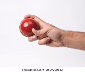 Closeup Photo Of A Male Bowler Strong Grip On A Gleaming Red Test Cricket Ball On White Background - Powered by Shutterstock