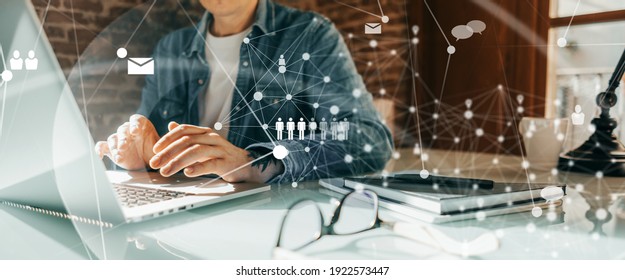 Close-up photo of male hands with laptop. Man working remotely at home. Concept of networking or remote work. Global business network. - Shutterstock ID 1922573447