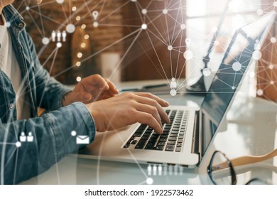 Close-up photo of male hands with laptop. Man working remotely at home. Concept of networking or remote work. Global business network. - Shutterstock ID 1922573462