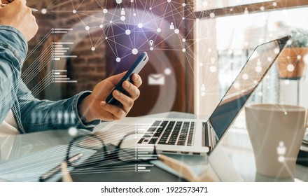 Close-up photo of male hands with laptop. Man working remotely at home. Concept of networking or remote work. Global business network. - Shutterstock ID 1922573471