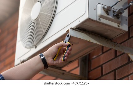 Closeup Photo Of Male Technician Installing Outdoor Air Conditioning Unit