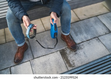 Close-up Photo Of Man's Hands Holding Pet Collar With A Leash. Broken Dog Owner With Grief Man Grieving About Lovely Friend And Deep Weeping About Animal Loss. Home Pets Relatives And Love Concept.