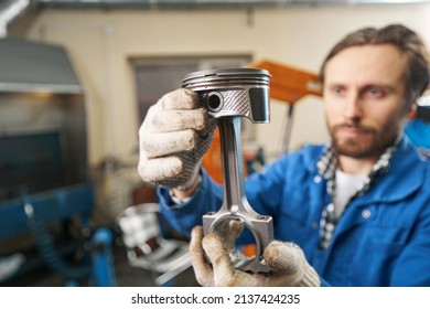 Close-up Photo Of Mechanic Holding Car Part In His Hands