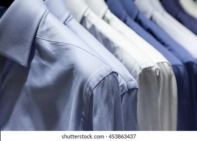 Closeup photo of Men's shirts hanging.