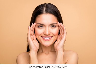 Closeup photo of naked latin lady natural beauty without makeup showing nice facial uplift procedure results hands on temples isolated beige pastel color background