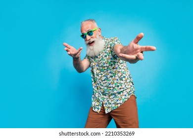 Closeup photo of old aged pensioner excited dancing wear tropical shirt celebrating opening new clothes shop empty space ad isolated on blue color background