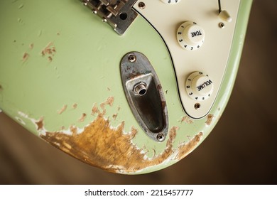 Closeup photo of an old guitar. Relic. Vintage music poster