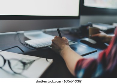 Closeup Photo On Female Hands That Use A Graphic Tablet And Stylus To Work Behind A Modern Computer Screen With Copy Space For Text, Logo Or Design. Soft Focus. Young Girl Working Distance