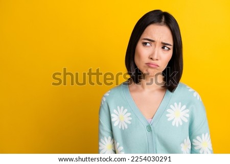 Closeup photo portrait of sad girl pouted lips look depressed looking empty space bad news announce information isolated on yellow color background 商業照片 © 