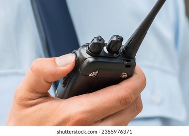 Close-up Photo Of Security Guard Holding Walkie-talkie