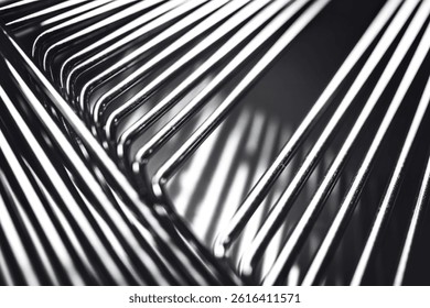 A close-up photo of several parallel, thin, and shiny wires