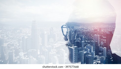 Closeup photo of stylish bearded banker wearing glasses and looking city. Double exposure, panoramic view contemporary megalopolis background. Space for your business message. Wide