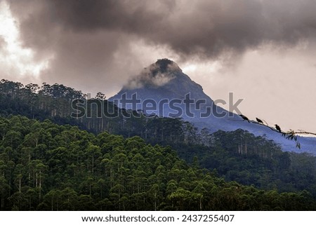 A close-up photo of the Temple on the top of Sri Pada mountain or Adam's Peak, surrounded by beautiful clouds.